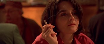 Movie still from “Bridget Jones's Diary” (2001), directed by Sharon Maguire – A woman is holding a cigarette in her hand; Close Up shot, Over the shoulder angle