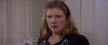 Movie still from “Bridget Jones's Diary” (2001), directed by Sharon Maguire – A person wearing a necklace; Close Up shot, Over the shoulder angle