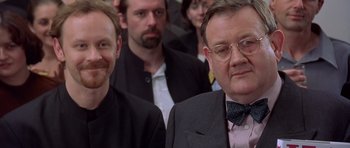 Movie still from “Bridget Jones's Diary” (2001), directed by Sharon Maguire – A group of men standing next to each other in a room; Close Up shot, Over the shoulder angle