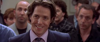 Movie still from “Bridget Jones's Diary” (2001), directed by Sharon Maguire – A person wearing a suit and tie; Close Up shot, Over the shoulder angle