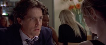 Movie still from “Bridget Jones's Diary” (2001), directed by Sharon Maguire – A person wearing a suit and tie; Close Up shot, Over the shoulder angle