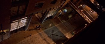 Movie still from “Bridget Jones's Diary” (2001), directed by Sharon Maguire – Two people are walking down the sidewalk at night; Extreme Wide shot, Overhead angle