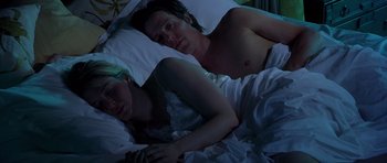 Movie still from “Bridget Jones's Diary” (2001), directed by Sharon Maguire – A man and a woman laying in a bed together; Medium shot, Overhead angle