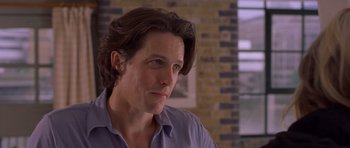 Movie still from “Bridget Jones's Diary” (2001), directed by Sharon Maguire – A person with long hair; Close Up shot, Over the shoulder angle