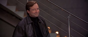 Movie still from “Bridget Jones's Diary” (2001), directed by Sharon Maguire – A man in a leather jacket smiling for the camera; Close Up shot, Low angle