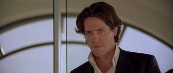 Movie still from “Bridget Jones's Diary” (2001), directed by Sharon Maguire – A person wearing a suit and tie; Close Up shot, Low angle