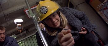 Movie still from “Bridget Jones's Diary” (2001), directed by Sharon Maguire – A woman wearing a yellow hard hat while looking at the camera; Close Up shot, Low angle