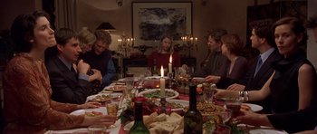 Movie still from “Bridget Jones's Diary” (2001), directed by Sharon Maguire – A group of people sitting around a dinner table; Medium shot, High angle