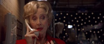 Movie still from “Bridget Jones's Diary” (2001), directed by Sharon Maguire – An older woman talking on a phone in a room; Close Up shot, Low angle