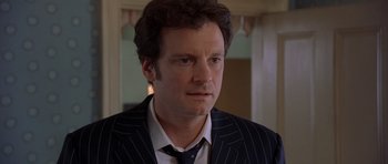 Movie still from “Bridget Jones's Diary” (2001), directed by Sharon Maguire – A man wearing a suit and tie in front of a mirror; Close Up shot, Over the shoulder angle