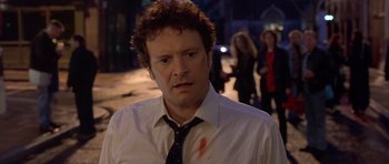 Movie still from “Bridget Jones's Diary” (2001), directed by Sharon Maguire – A man in a white dress shirt and tie with blood on his shirt; Close Up shot, Over the shoulder angle