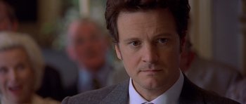 Movie still from “Bridget Jones's Diary” (2001), directed by Sharon Maguire – A person wearing a suit and tie; Close Up shot, Over the shoulder angle