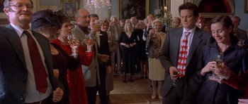 Movie still from “Bridget Jones's Diary” (2001), directed by Sharon Maguire – A group of people standing in a room holding wine glasses; Medium shot, Low angle