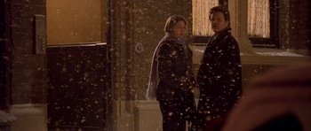 Movie still from “Bridget Jones's Diary” (2001), directed by Sharon Maguire – Two people standing outside in the snow at night; Medium shot, Over the shoulder angle