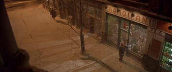 Movie still from “Bridget Jones's Diary” (2001), directed by Sharon Maguire – A person walking down a snowy street at night; Extreme Wide shot, High angle