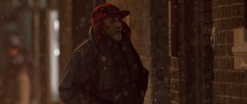 Movie still from “Bridget Jones's Diary” (2001), directed by Sharon Maguire – A man with a red hat standing in the snow; Medium shot, Over the shoulder angle