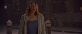 Movie still from “Bridget Jones's Diary” (2001), directed by Sharon Maguire – A woman standing on a sidewalk near a fire hydrant; Medium shot, Over the shoulder angle