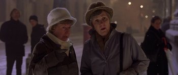 Movie still from “Bridget Jones's Diary” (2001), directed by Sharon Maguire – Two older women standing next to each other on a street; Close Up shot, High angle