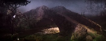 Movie still from “Brigadoon” (1954), directed by Vincente Minnelli – A stone bridge is lit up at night; Extreme Wide shot, High angle