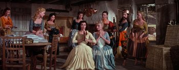 Movie still from “Brigadoon” (1954), directed by Vincente Minnelli – A group of women dressed in medieval clothing; Wide shot, Low angle
