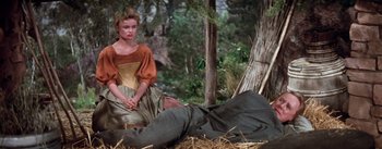 Movie still from “Brigadoon” (1954), directed by Vincente Minnelli – A woman sitting on the ground next to a dead body; Medium shot, High angle