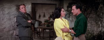 Movie still from “Brigadoon” (1954), directed by Vincente Minnelli – A man and a woman in a room with a table; Medium shot, Over the shoulder angle