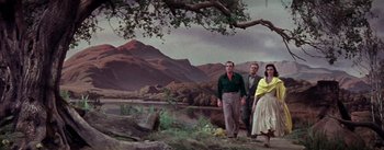 Movie still from “Brigadoon” (1954), directed by Vincente Minnelli – A group of people standing next to a body of water; Wide shot, Low angle