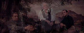 Movie still from “Brigadoon” (1954), directed by Vincente Minnelli – An old man is standing in front of a painting; Medium shot, Low angle