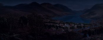 Movie still from “Brigadoon” (1954), directed by Vincente Minnelli – A night view of a town and a mountain range; Extreme Wide shot, High angle