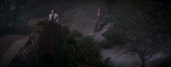 Movie still from “Brigadoon” (1954), directed by Vincente Minnelli – Two men standing on steps in the middle of the night; Wide shot, High angle