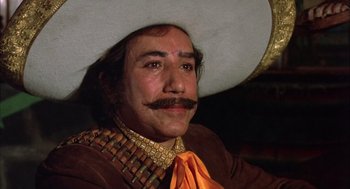 Movie still from “Bring Me the Head of Alfredo Garcia” (1974), directed by Sam Peckinpah – A man with a mustache wearing a cowboy hat; Close Up shot, Low angle