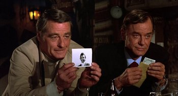 Movie still from “Bring Me the Head of Alfredo Garcia” (1974), directed by Sam Peckinpah – A man holding up a picture of himself; Close Up shot, High angle