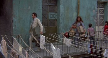 Movie still from “Bring Me the Head of Alfredo Garcia” (1974), directed by Sam Peckinpah – A man and a woman walking down the stairs; Wide shot, Low angle