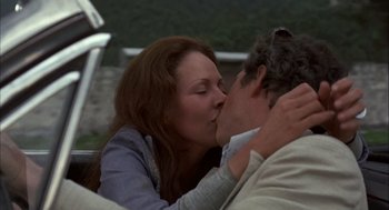 Movie still from “Bring Me the Head of Alfredo Garcia” (1974), directed by Sam Peckinpah – A man and a woman kissing on a bench; Close Up shot, Low angle