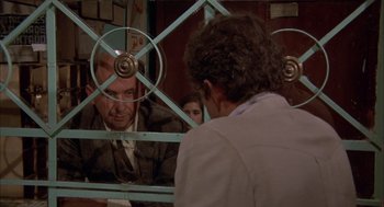 Movie still from “Bring Me the Head of Alfredo Garcia” (1974), directed by Sam Peckinpah – A man and a woman looking at each other in front of a mirror; Medium shot, Over the shoulder angle