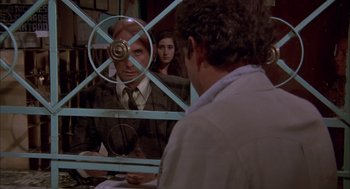 Movie still from “Bring Me the Head of Alfredo Garcia” (1974), directed by Sam Peckinpah – A man and a woman looking in a mirror; Medium shot, Over the shoulder angle