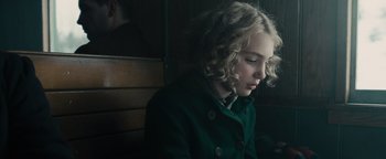 Movie still from “The Book Thief” (2013), directed by Brian Percival – A woman sitting on top of a wooden bench; Close Up shot, Over the shoulder angle