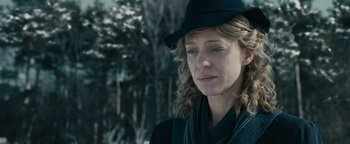 Movie still from “The Book Thief” (2013), directed by Brian Percival – A person wearing a hat with trees in the background; Close Up shot, Over the shoulder angle