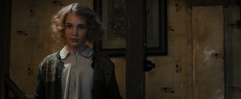 Movie still from “The Book Thief” (2013), directed by Brian Percival – A young woman standing in a room with a picture on the wall; Close Up shot, Low angle