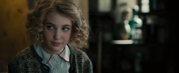 Movie still from “The Book Thief” (2013), directed by Brian Percival – A young girl with blonde curly hair wearing a white shirt; Close Up shot, Over the shoulder angle
