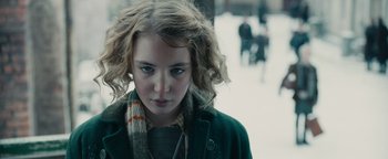Movie still from “The Book Thief” (2013), directed by Brian Percival – A young woman with a scarf and a coat; Close Up shot, Over the shoulder angle