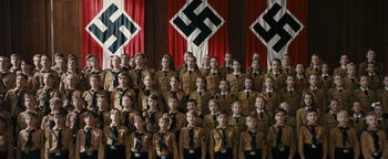 Movie still from “The Book Thief” (2013), directed by Brian Percival – A group of young people in uniforms in front of a nazi flag; Wide shot, High angle