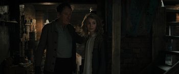 Movie still from “The Book Thief” (2013), directed by Brian Percival – A man and a woman standing next to each other in the dark; Medium shot, Over the shoulder angle