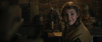 Movie still from “The Book Thief” (2013), directed by Brian Percival – A young girl is smiling for the camera in a room; Close Up shot, High angle