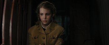 Movie still from “The Book Thief” (2013), directed by Brian Percival – A young girl in a military uniform looking at the camera; Close Up shot, Over the shoulder angle