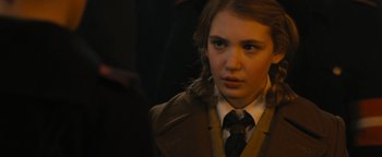 Movie still from “The Book Thief” (2013), directed by Brian Percival – A woman in a suit and tie looking at the camera; Close Up shot, Over the shoulder angle