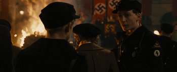 Movie still from “The Book Thief” (2013), directed by Brian Percival – A group of people standing next to each other in front of nazi flags; Close Up shot, Over the shoulder angle