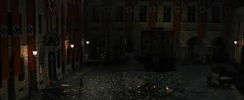 Movie still from “The Book Thief” (2013), directed by Brian Percival – A man standing in the middle of a street at night; Extreme Wide shot, High angle
