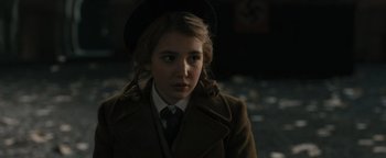 Movie still from “The Book Thief” (2013), directed by Brian Percival – A young girl in a hat and a coat; Close Up shot, Over the shoulder angle