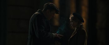 Movie still from “The Book Thief” (2013), directed by Brian Percival – A man and a woman standing next to each other in the dark; Medium shot, Over the shoulder angle
